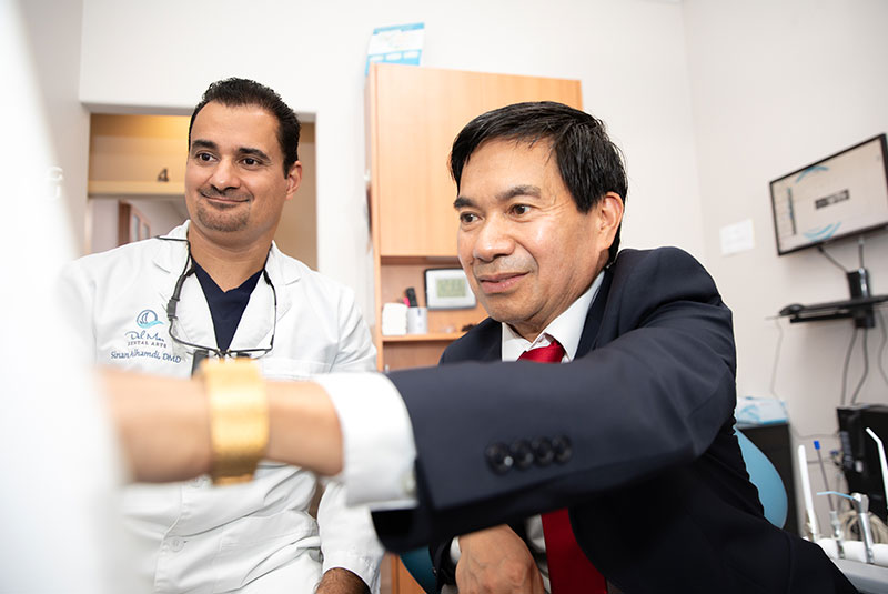 doctor and Patient pointing at dental x-ray